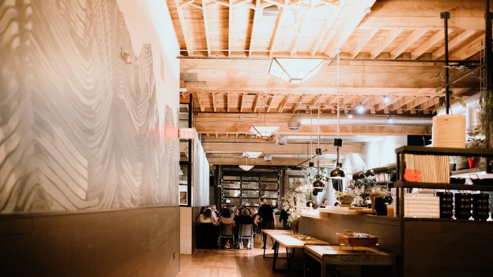 Stylish restaurant interior featuring wooden ceiling and contemporary decor.