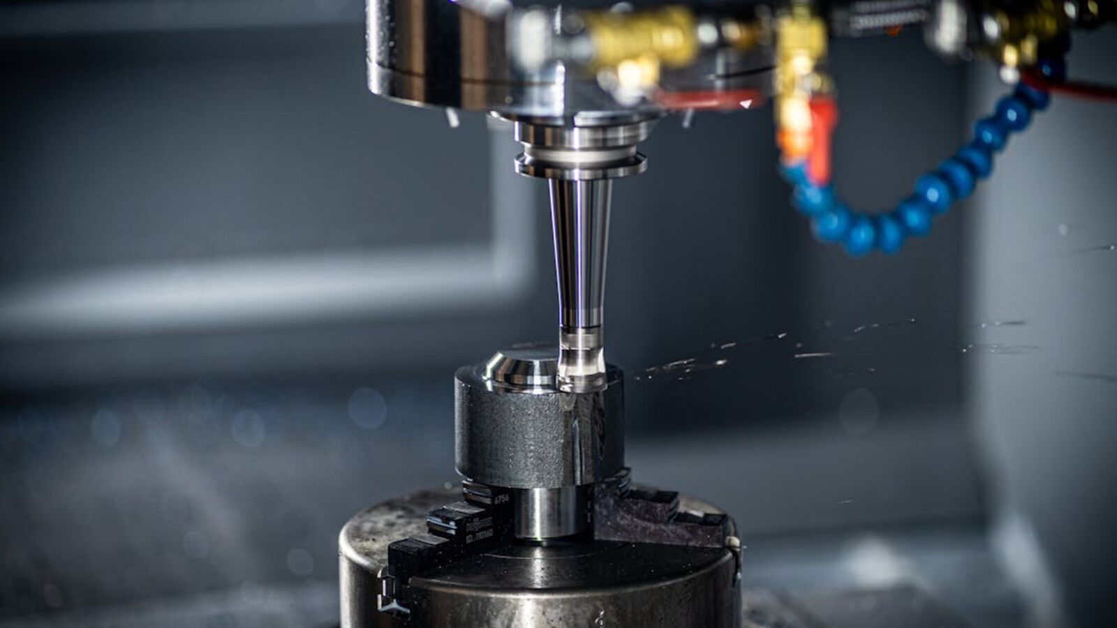 Close-up of CNC machine in action, showcasing precision engineering and industrial equipment.