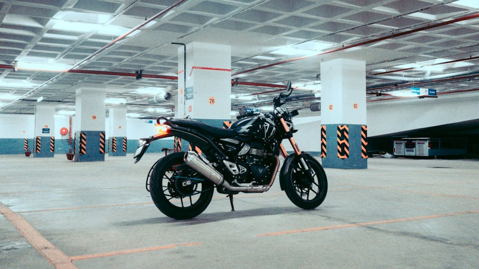 A sleek motorcycle parked in a spacious underground garage, capturing urban adventure vibes.